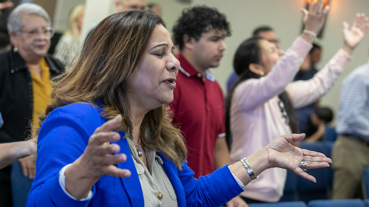 Fatima Guzman prays during a church service