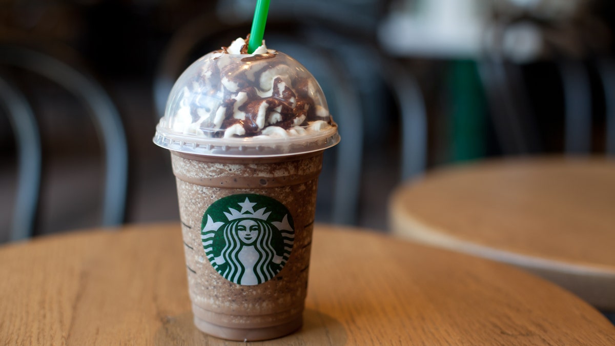 A Frappuccino from Starbucks sits on a table.