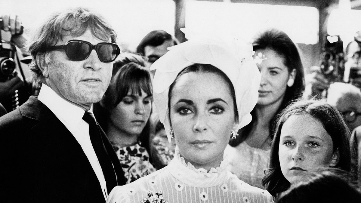 Elizabeth Taylor with her family on an ocean liner looking serious.