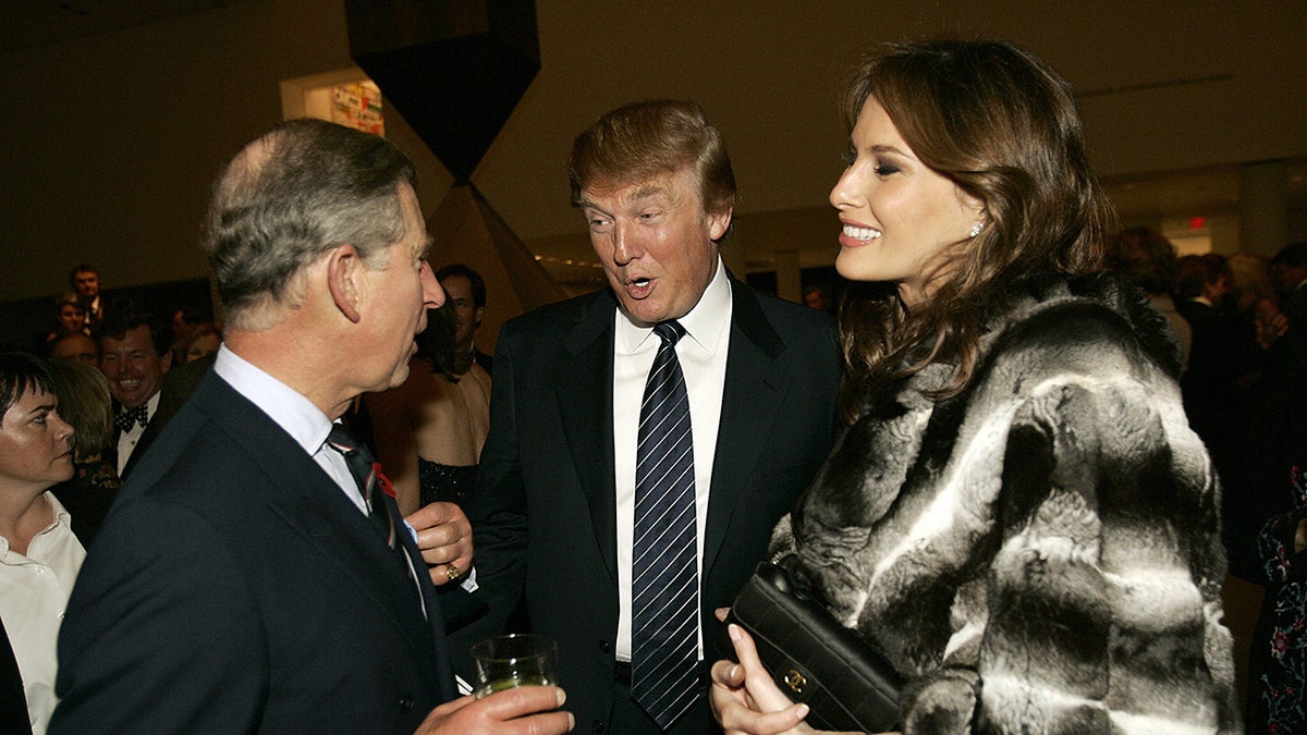President Trump chatting with the former Prince Charles as Melania Trump smiles and looks on.