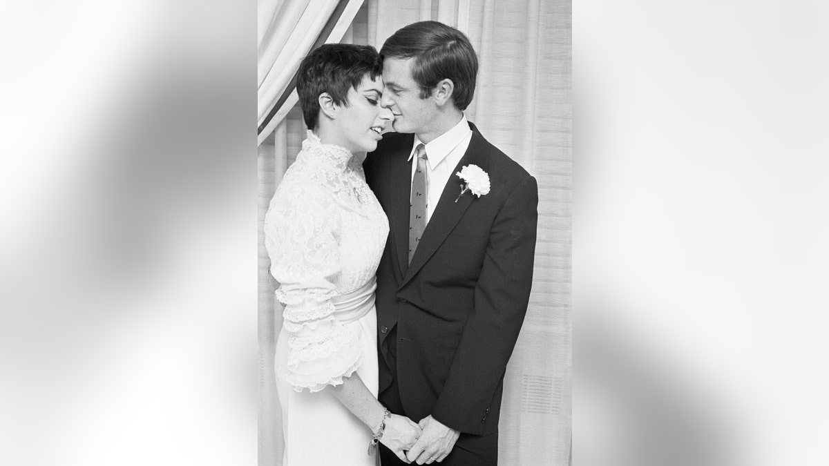 Liza Minnelli leaning on Peter Allen on their wedding day.