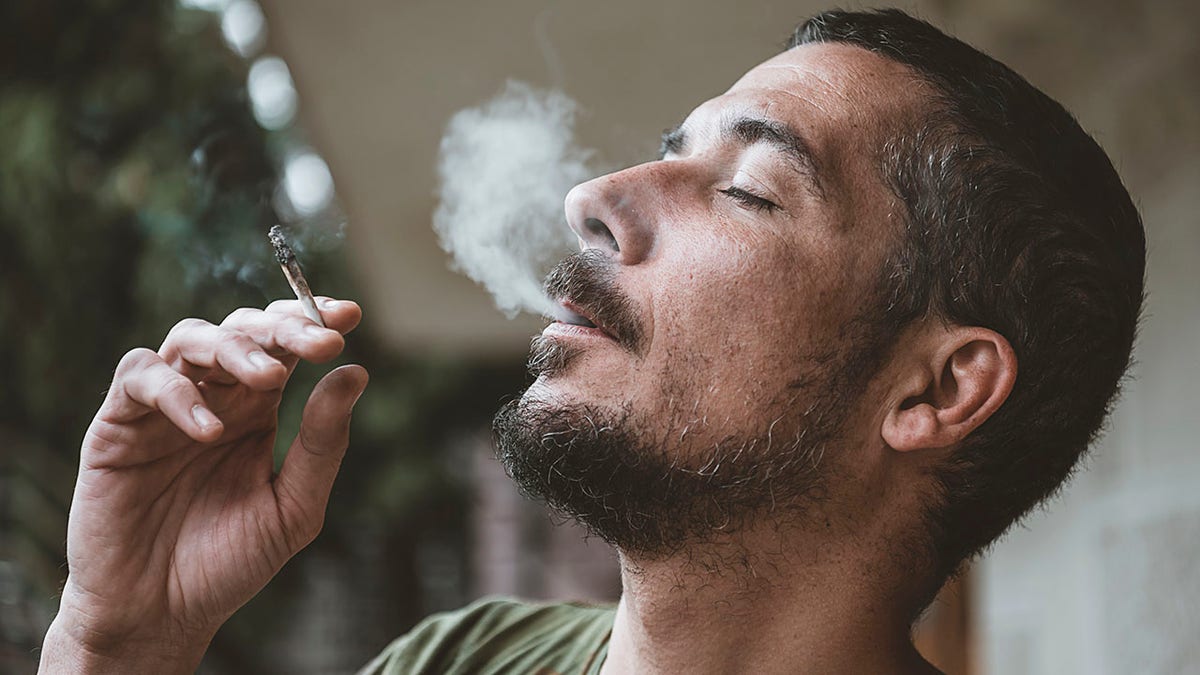 man smokes marijuana