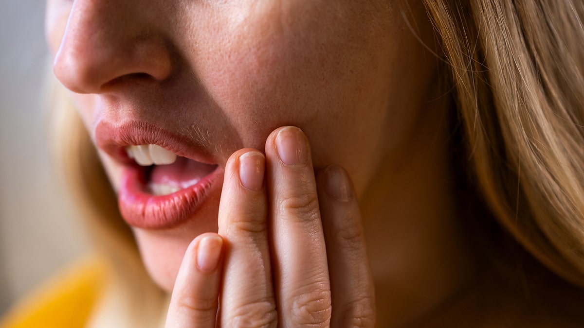 A woman who suffers from pain in the mouth or dental pain