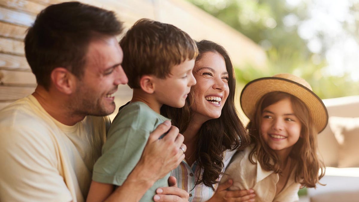 Parents with their kids during a spring day on a patio.