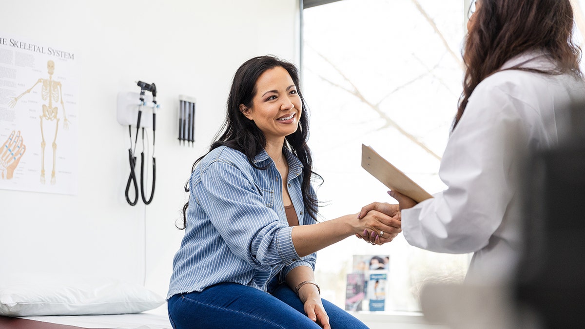 doctor with patient in clinical setting stock image