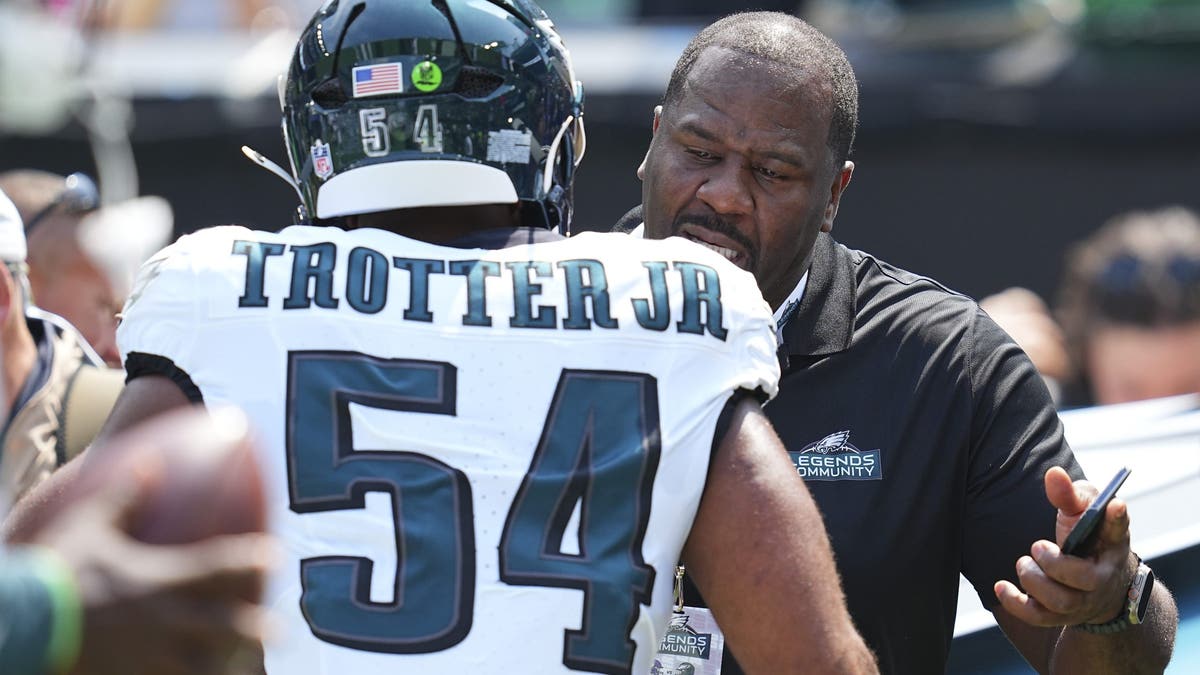 Jeremiah Trotter Jr. hugs his father