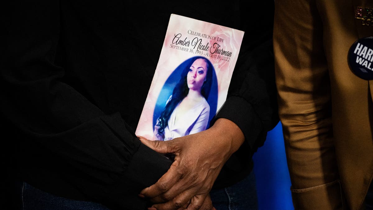 Shanette Williams, the mother of Amber Nicole Thurman, holds a photo of her daughter