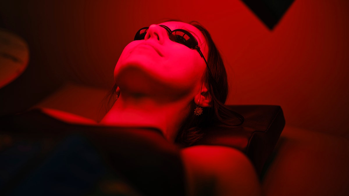 Person who receives red light therapy while he lays horizontally