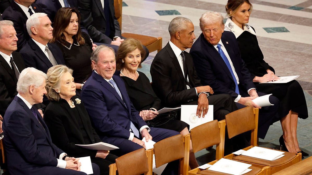 Trump hats with Obama, with pencil has placed behind then, in Carter Funerer