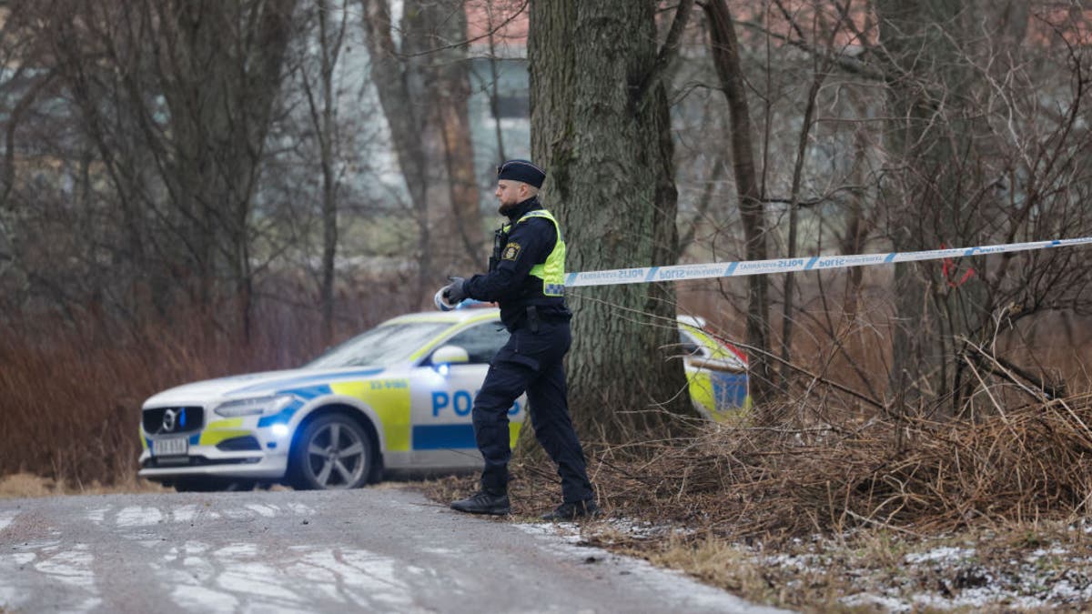 A police officer cordons off an area near the Risbergska School in Orebro, Sweden, on February 4, 2025, following reports of a serious violent crime. Five people were shot and wounded at a school in the central Swedish city of Orebro on Tuesday, police said, adding that a large operation was underway and urging people to stay away from the area. (Photo by Kicki NILSSON / TT NEWS AGENCY / AFP) / Sweden OUT (Photo by KICKI NILSSON/TT NEWS AGENCY/AFP via Getty Images)