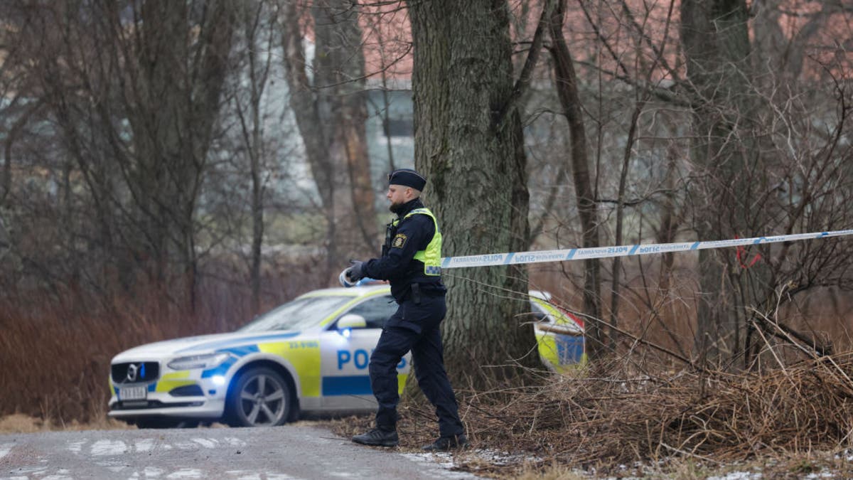 A police officer cordons off an area near the Risbergska School in Orebro, Sweden, on February 4, 2025, following reports of a serious violent crime. Five people were shot and wounded at a school in the central Swedish city of Orebro on Tuesday, police said, adding that a large operation was underway and urging people to stay away from the area. (Photo by Kicki NILSSON / TT NEWS AGENCY / AFP) / Sweden OUT (Photo by KICKI NILSSON/TT NEWS AGENCY/AFP via Getty Images)