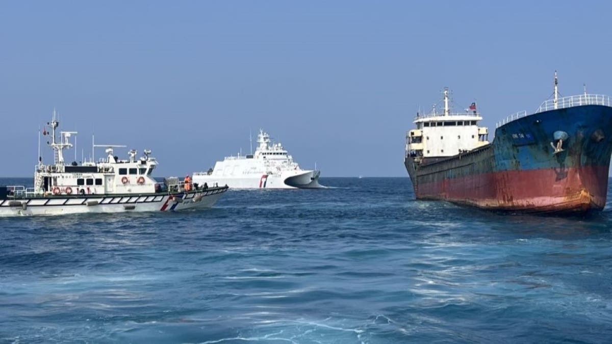 Two staff of the Taiwan Coast Guard addresses a cargo ship with Togo flag to carry out the inspection on February 25, 2025.