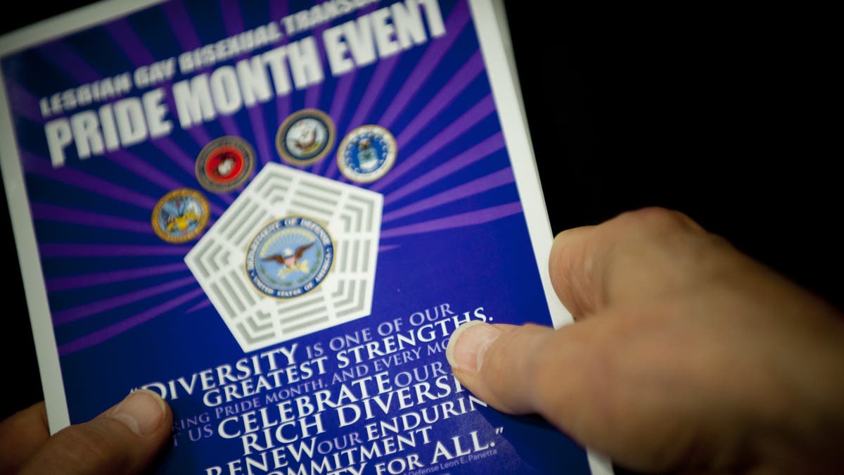 Close up of hands holding a pamphlet at the Pentagon during a Lesbian, Gay, Bi-Sexual, and Transgender Pride Month event. DOD photo by U.S. Navy Petty Officer 1st Class Chad J. McNeeley. 2015