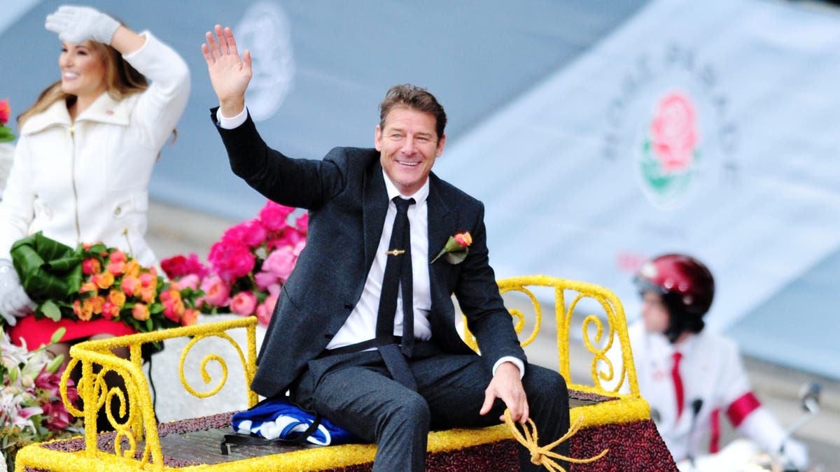 Ty Pennington waving as he rides a float