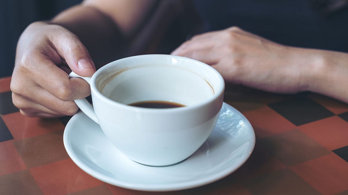 hand holding and drinking hot coffee