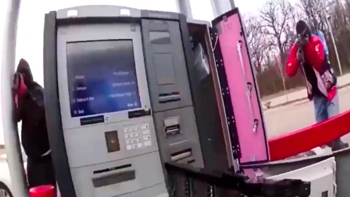 A group of brazen thieves were seen pointing assault rifles in the face of a cash-in-transit guard before making off with large sums of cash from an ATM machine, wild video released by police in Tennessee shows.