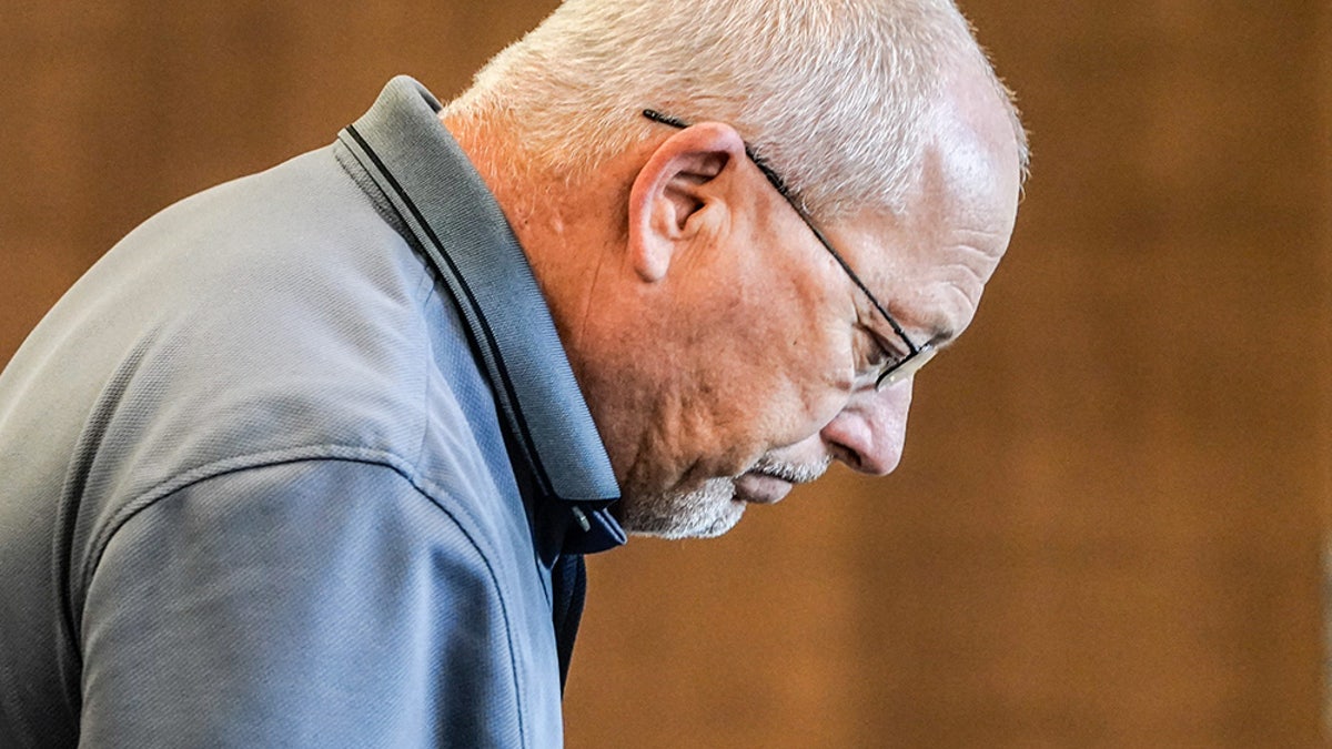 Jeff Jellison looking down to the side wearing a blue collared shirt.