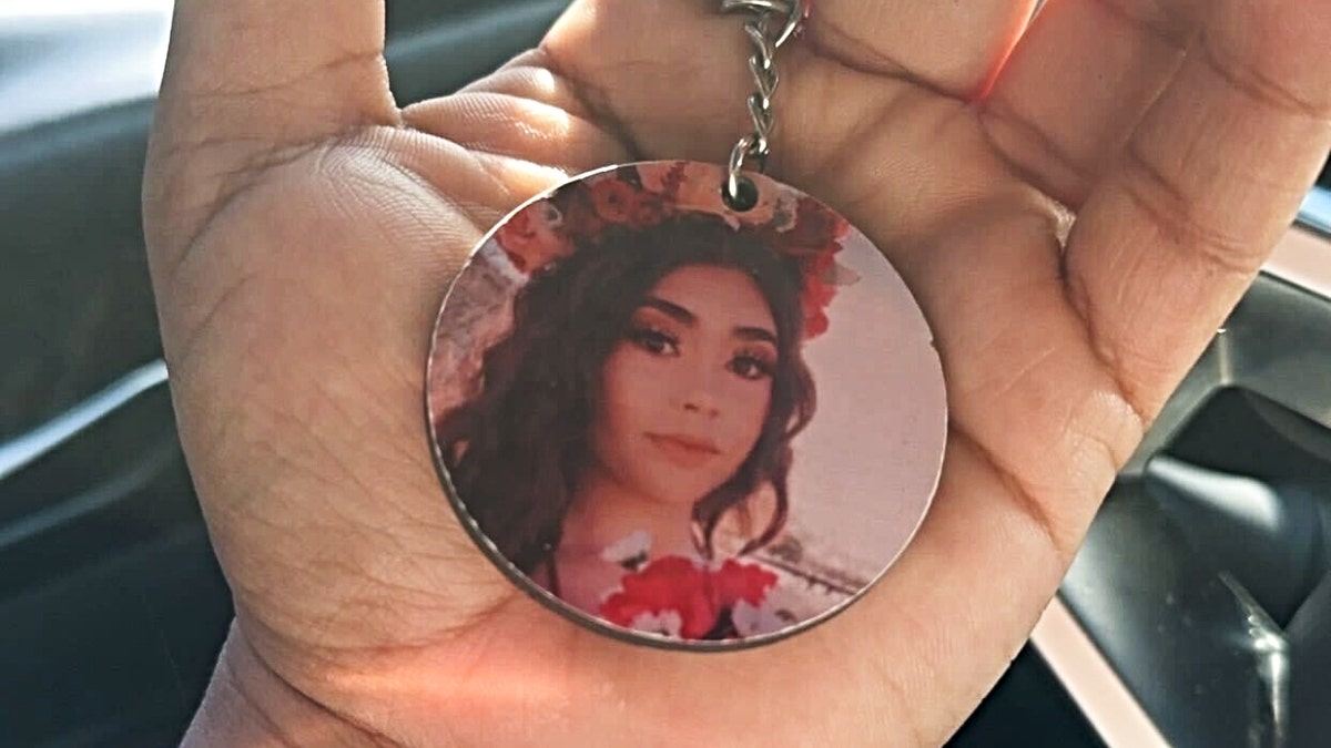 A key chain showing a photo of Lizbeth Medina in Jacqueline Medina's hand