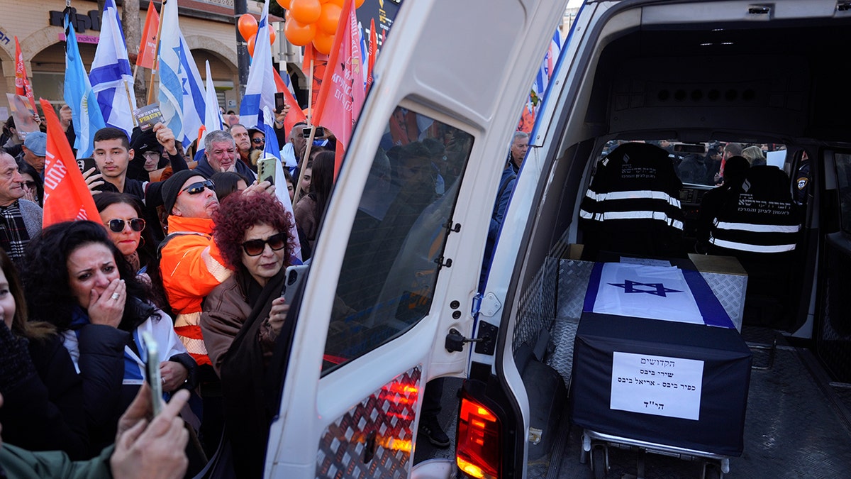 Mourners in Israel around vehicle carrying coffin of Shiri Bibas and her two children, Ariel and Kfir