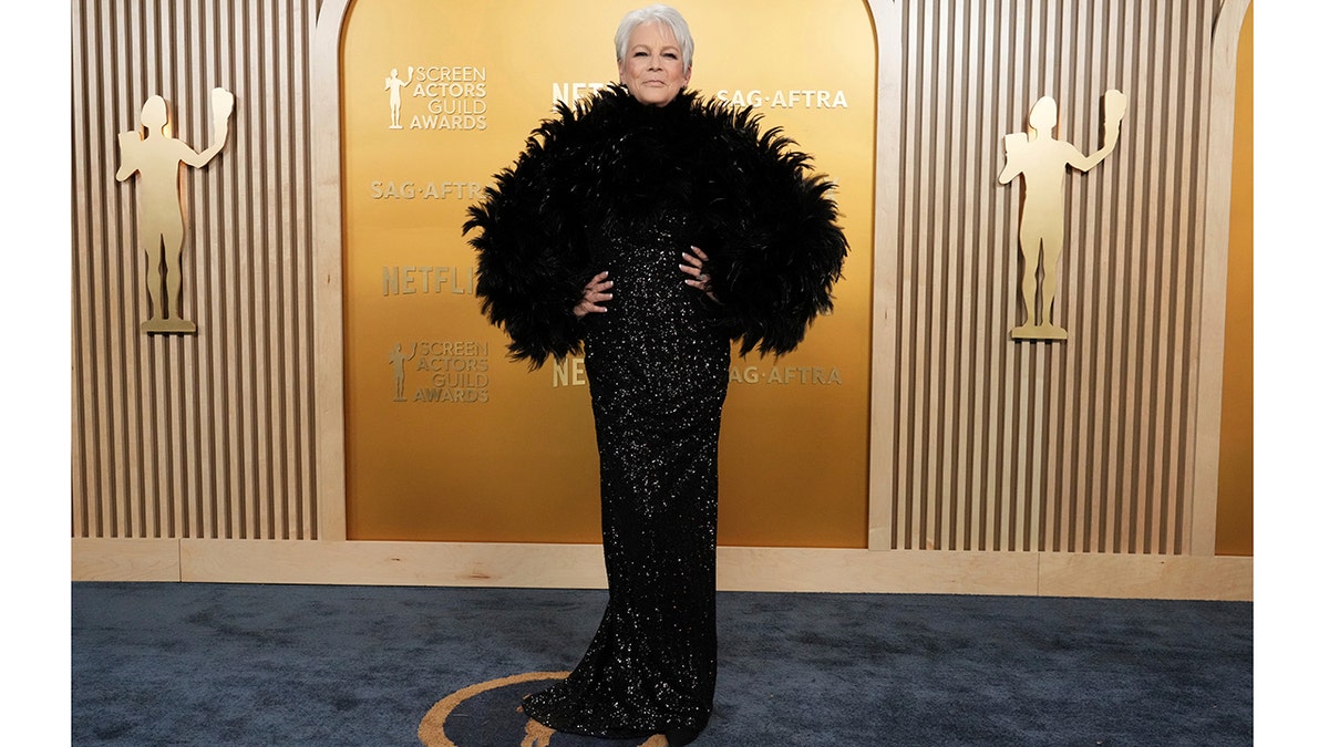 Jamie Lee Curtis rocks black feather boa at Screen Actors Guild awards.