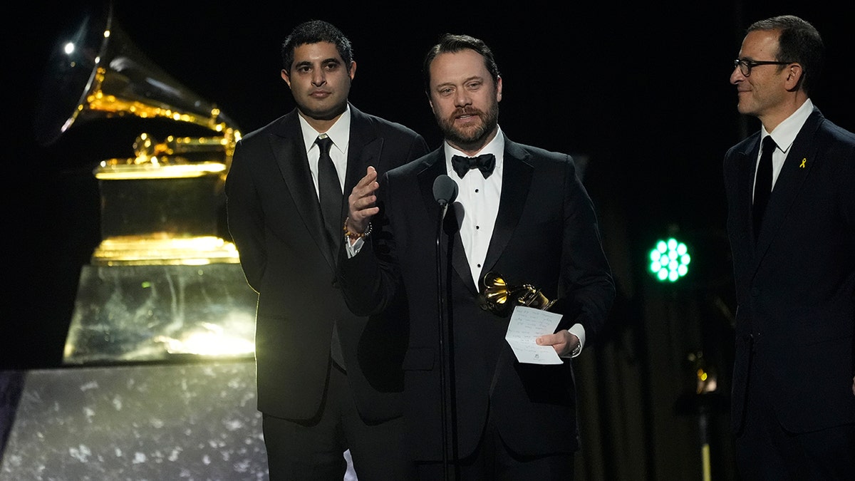 Kabir Sehgal, left, and President Carter's grandson, Jason Carter, judge  the award