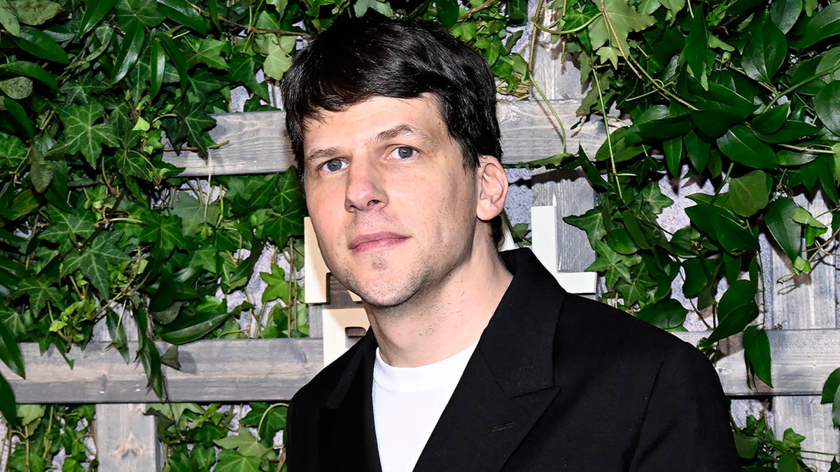 jesse eisenberg lasting  successful  beforehand   of an ivy background