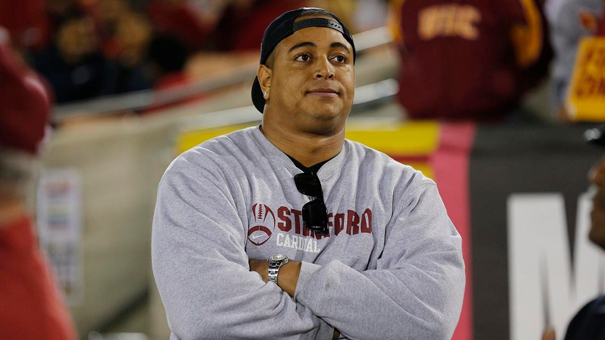 Jonathan Martin folded arms looking on