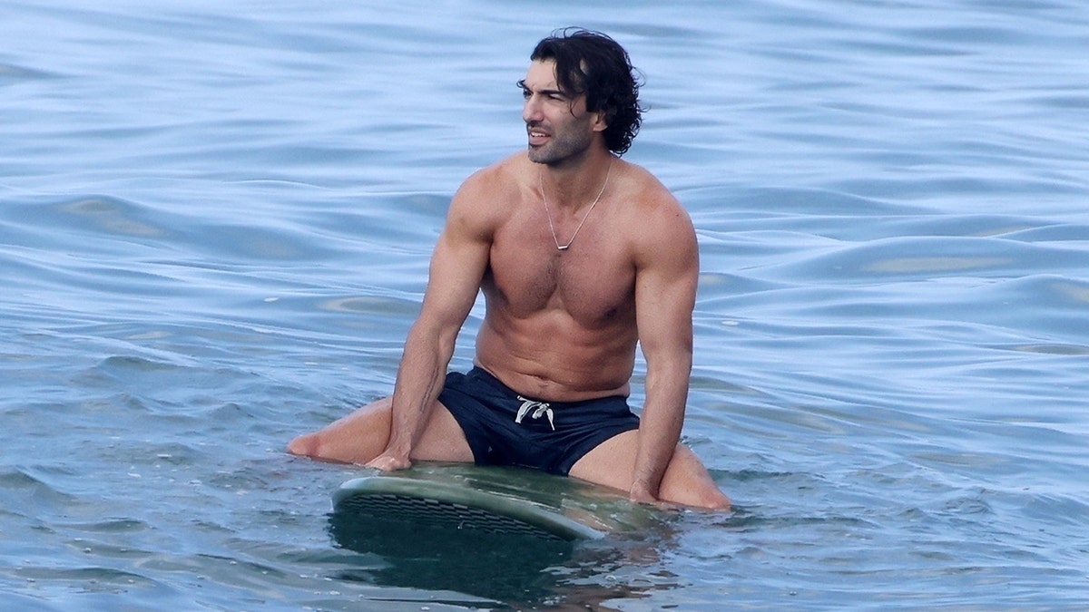 Blake Lively's counterpart in the lawsuit, Justin Baldoni shirtless on a surfboard in Hawaii