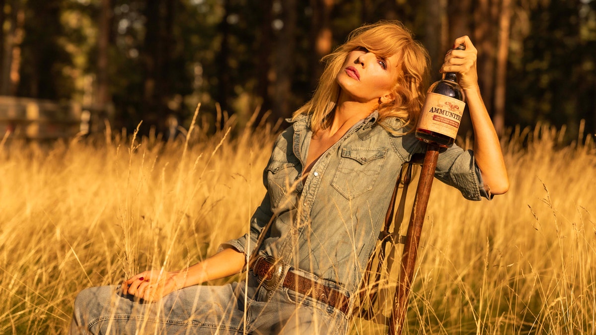 "Yellowstone" histrion   Kelly Reilly holds a vessel  of Ammunition whiskey during a photography league   for the California-based whiskey and vino  maker.