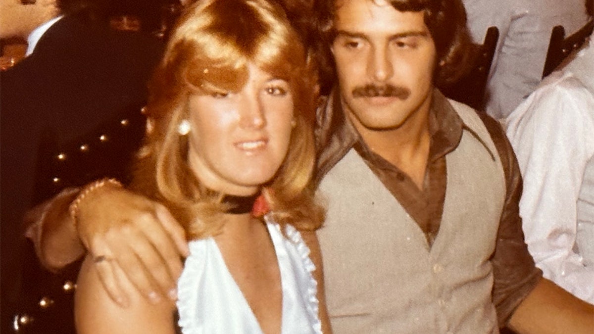 Ken Tekiela with his arm around a smiling Holly