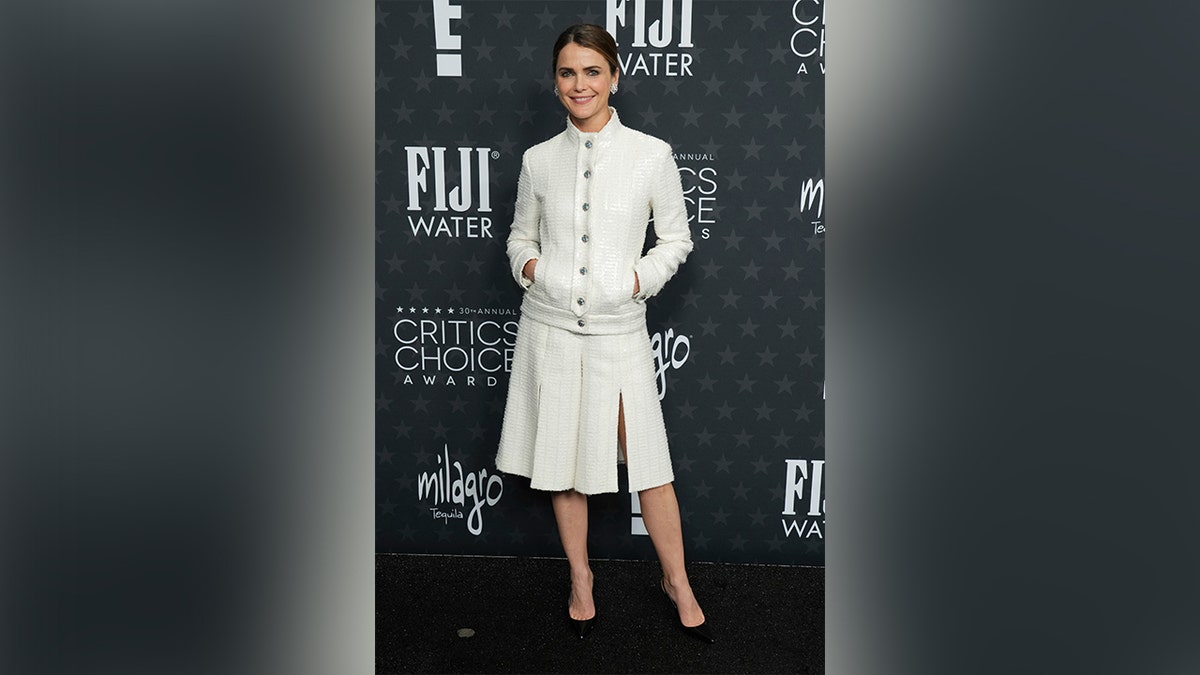 Keri Russel wore a white long sleeve jacket with buttons down the middle, and a matching white skirt.