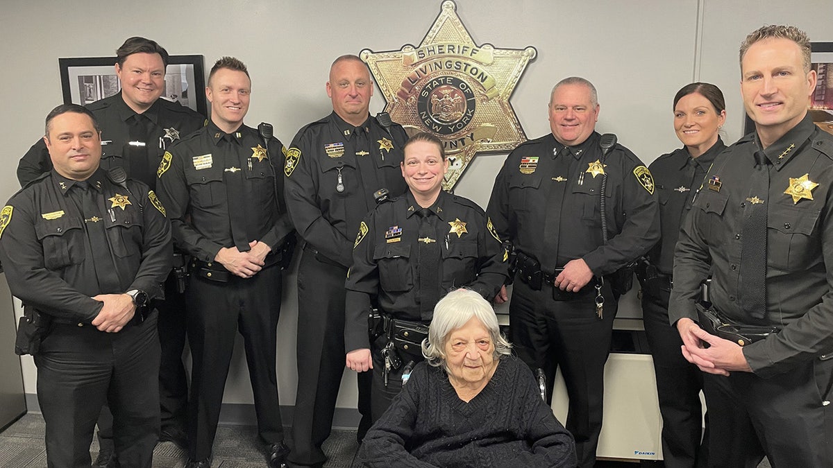 Sheriff's office taking a photo with the old woman.