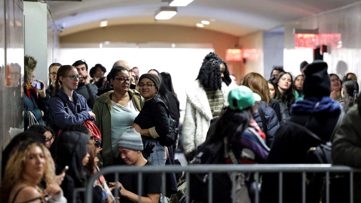 Supporters of Luigi Mangione stand outside of a NYC courtroom