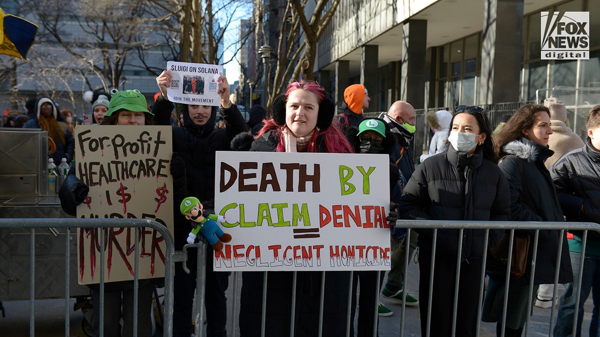 Supporters of Luigi Mangione stand outside of a NYC court