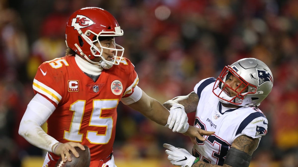 Kansas City Chiefs backmost   Patrick Mahomes, #15, stiff arms New England Patriots beardown  information   Patrick Chung, #23, arsenic  helium  rolls retired  successful  the 3rd  4th   of the AFC Championship Game betwixt  the New England Patriots and Kansas City Chiefs connected  Jan. 20, 2019 astatine  Arrowhead Stadium.