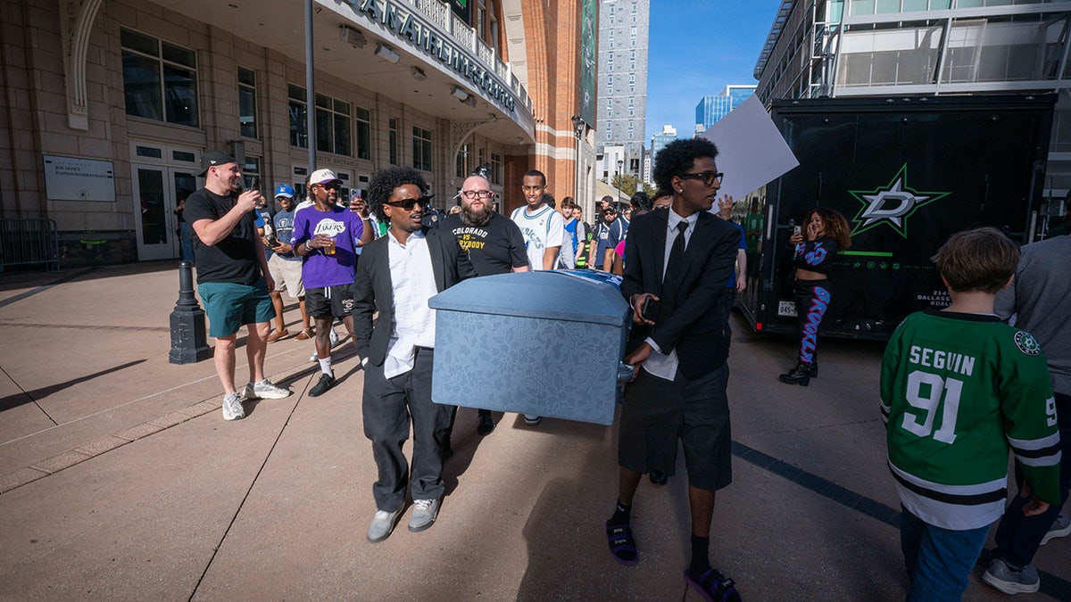 Mavericks fans carry coffin outside arena