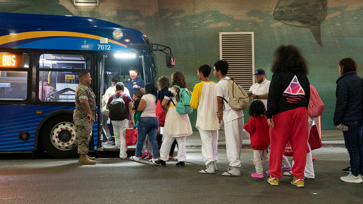 Migrants get on bus in NYC