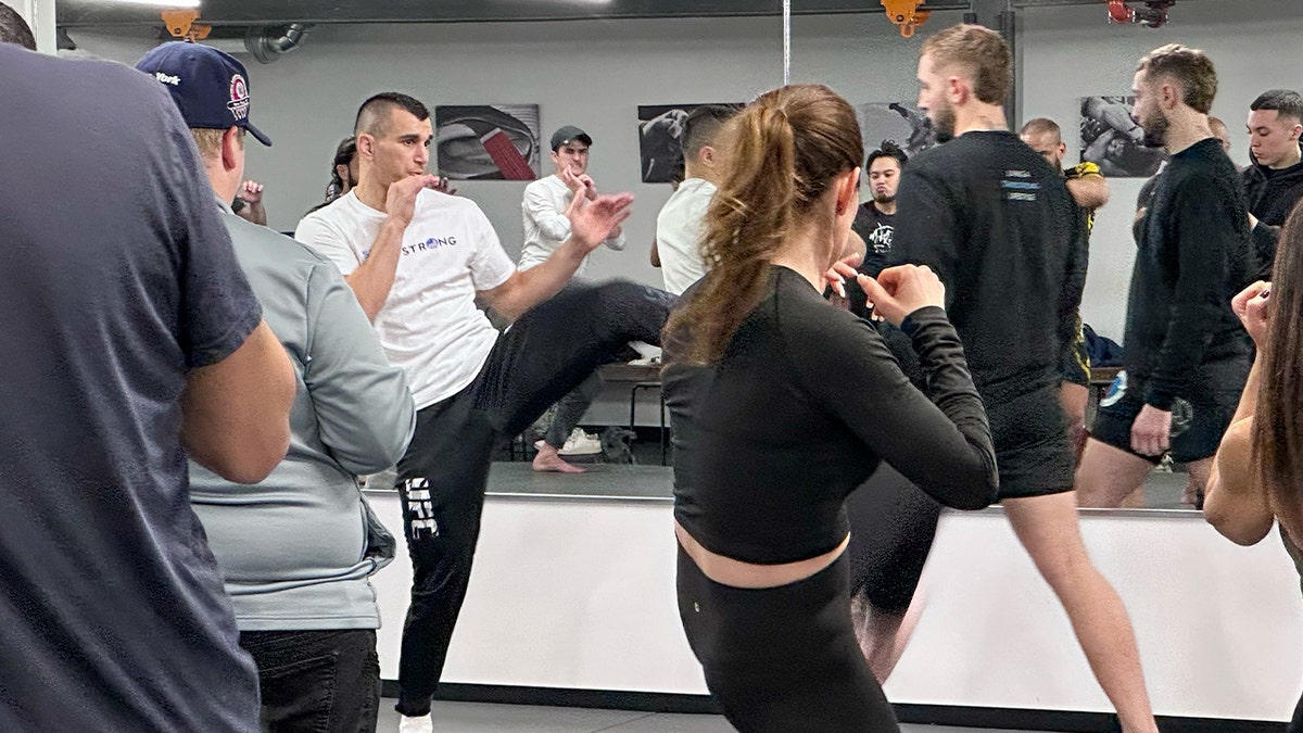 Natan Levy shows students a kick move during a seminar