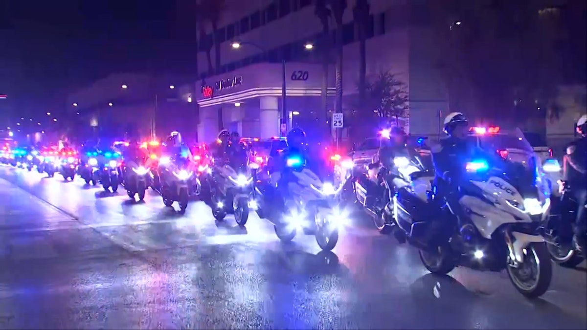 North Las Vegas Police Department (NLVPD) officers thrust   motorcycles successful  procession for a slain chap  officer.