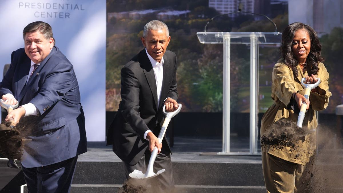 Illinois Governor J.B. Pritzker (L) joins former U.S. President Barack Obama and former first lady Michelle Obama in a ceremonial groundbreaking