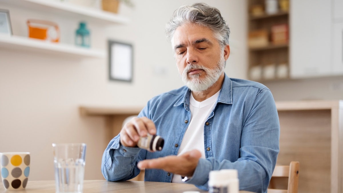 Older man taking pills