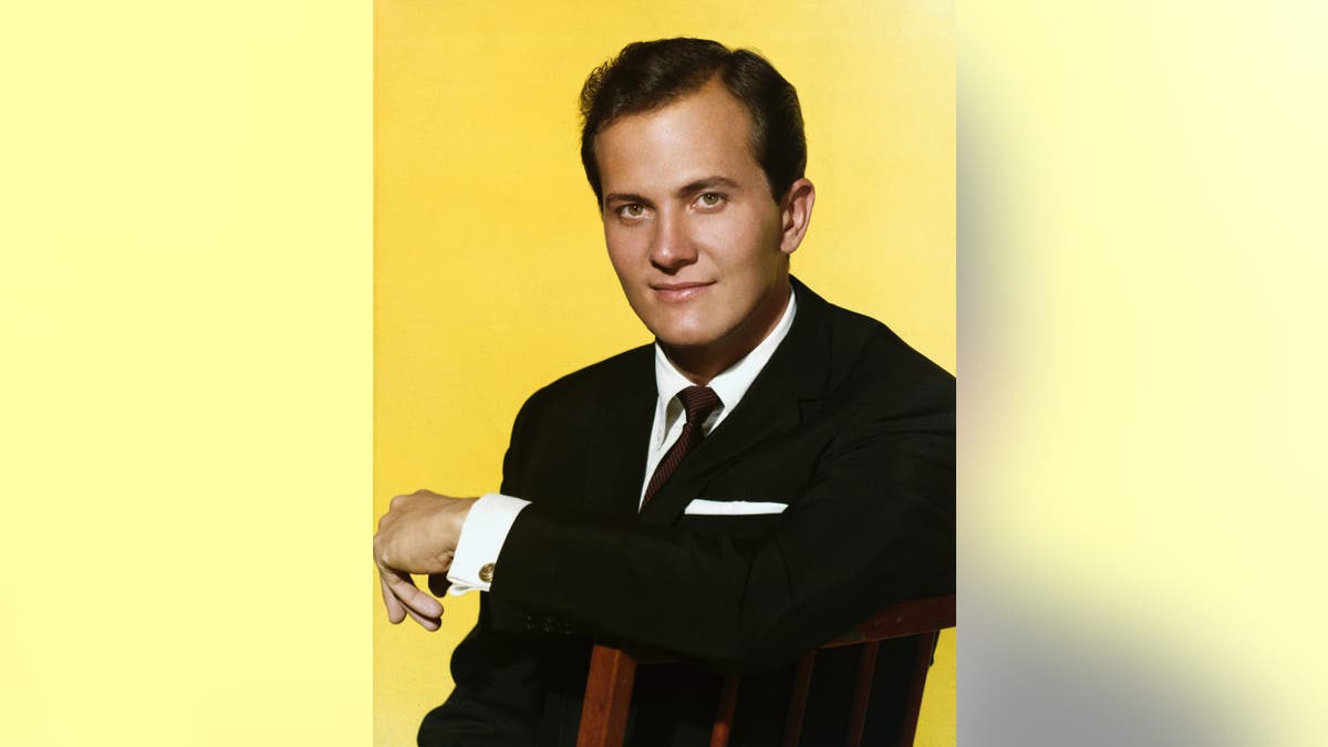 Pat Boone with a yellow background