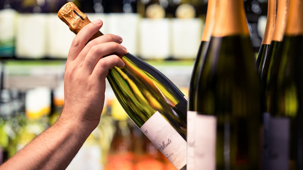 A person selecting sparkling wine.