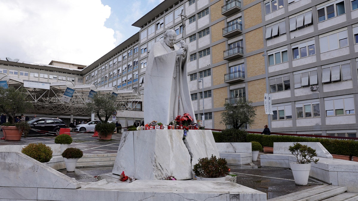 A statue of the late Pope John Paul II outside Gemelli Hospital