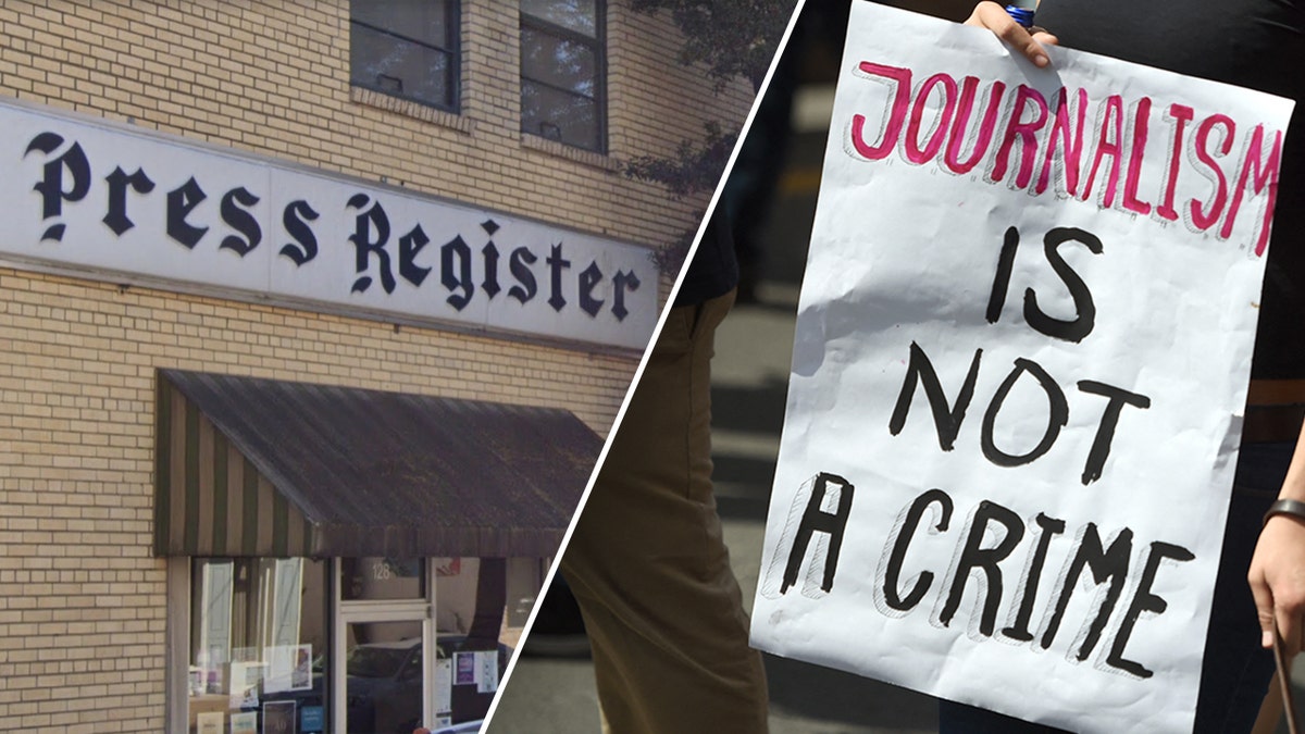 Clarksdale Press Register sign next to a sign reading "Journalism is not a crime"