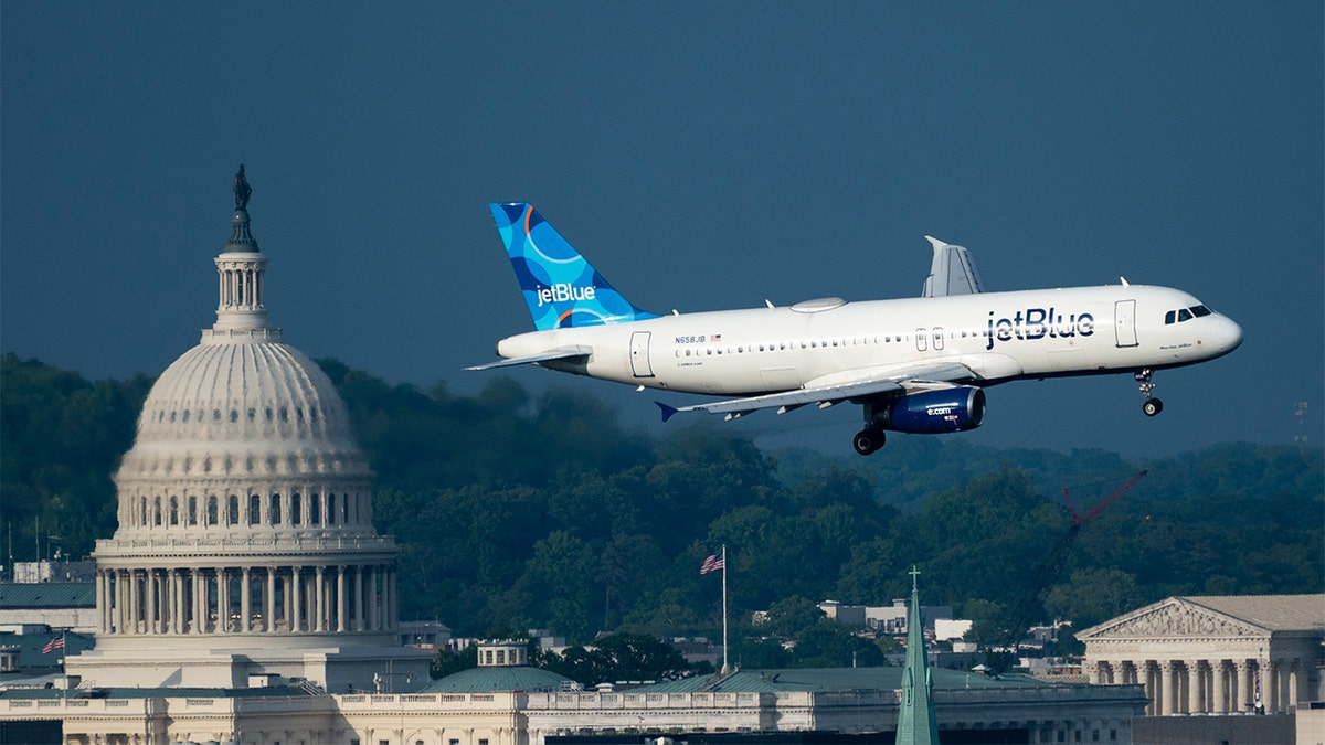 JetBlue Airlines Airbus A320 flies from the Reagan National Airport with the United States Capitol in the background