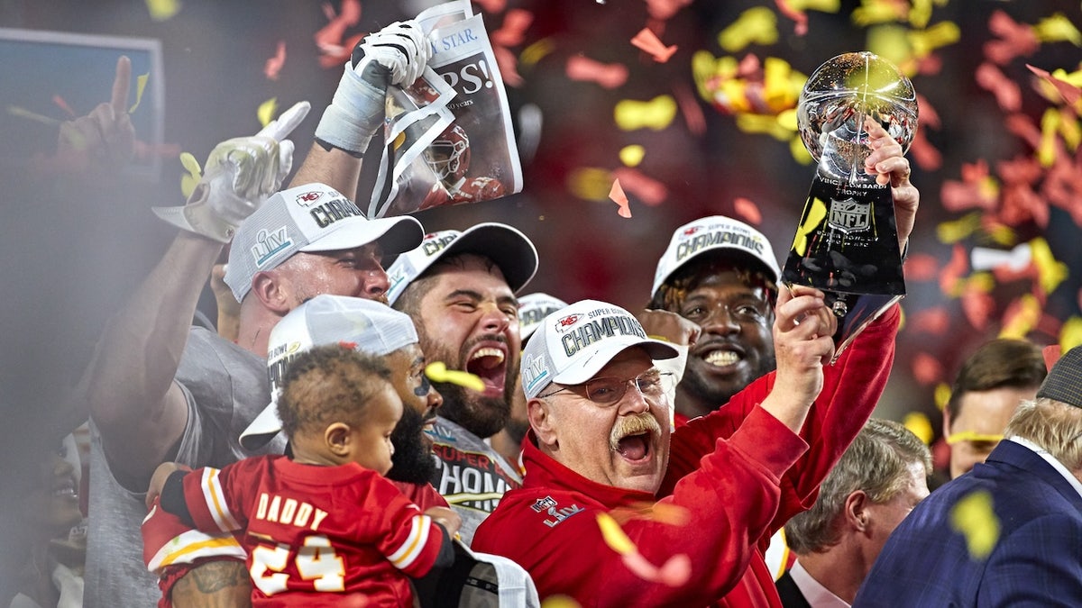 Kansas City Chiefs manager  Andy Reid victorious, holding up   the Vince Lombardi trophy aft  winning Super Bowl LIV against the San Francisco 49ers astatine  Hard Rock Stadium.