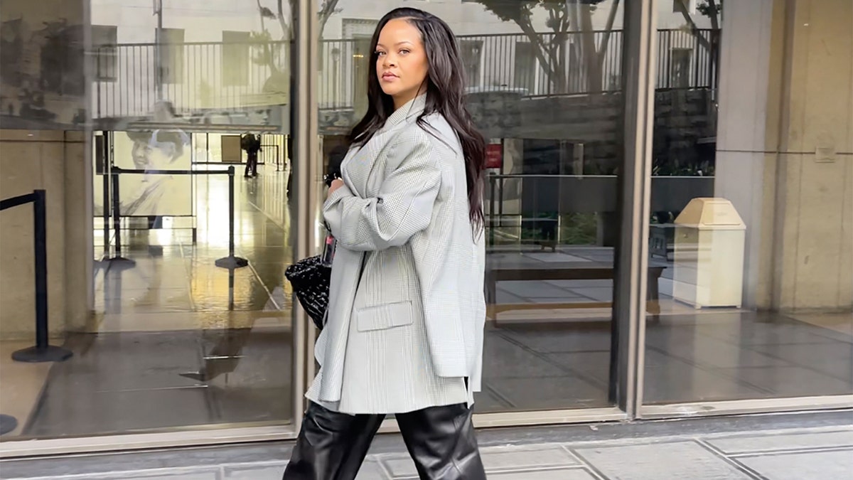 Rihanna wears grey blazer and leather slacks