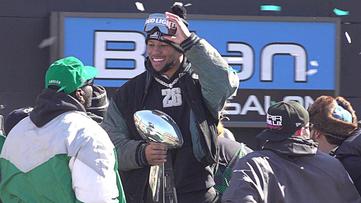 Philadelphia Eagles running back Saquon Barkley holds the Vince Lombardi Trophy during the Eagles' Super Bowl championship parade on Friday.