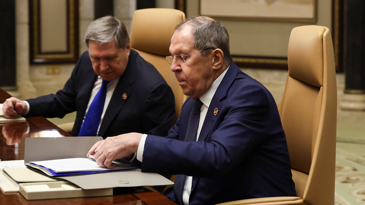 Russian Foreign Minister Sergei Lavrov, right, sits next to Russian President Vladimir Putin's foreign policy advisor Yuri Ushakov